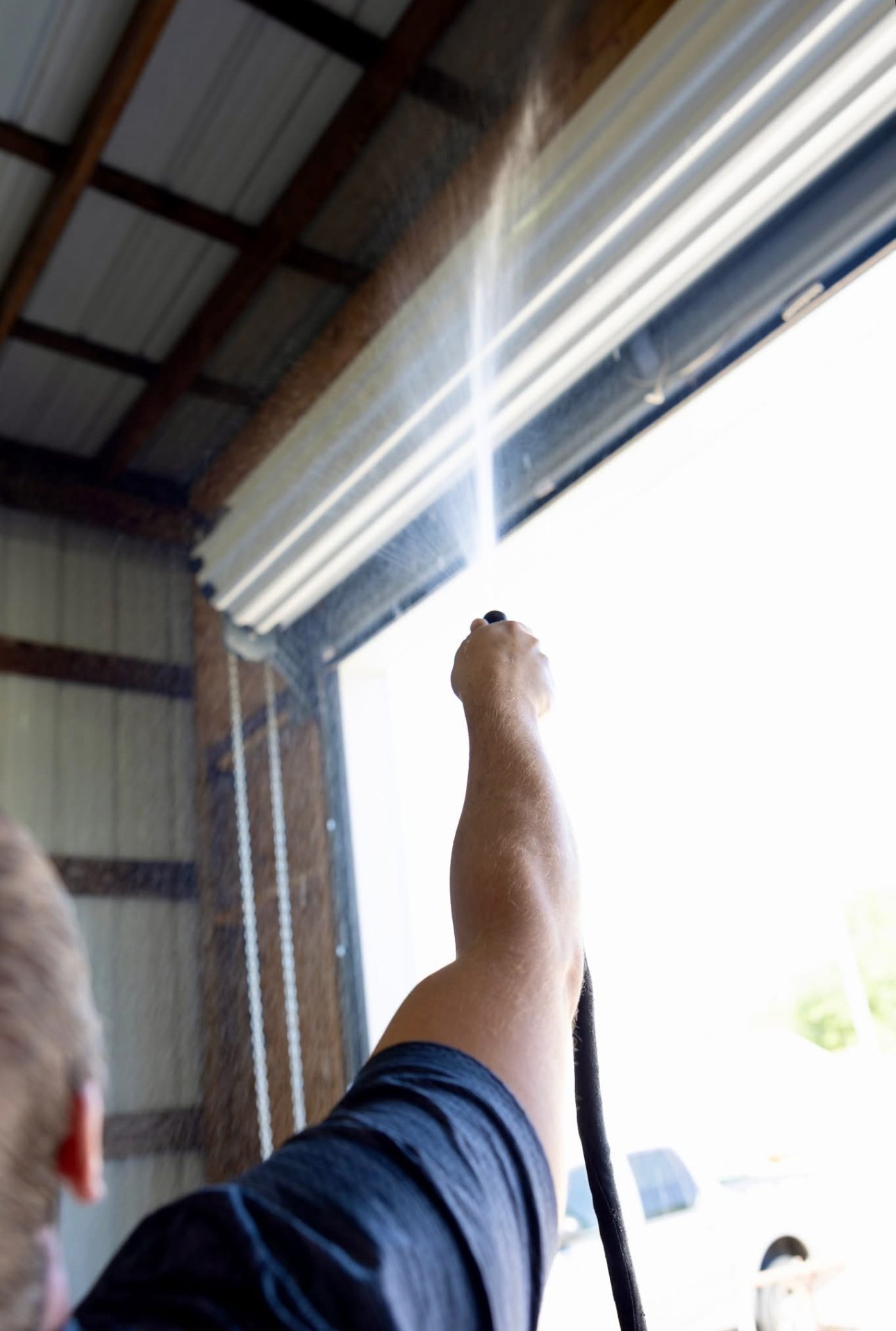 Spray foam being applied to metal building ceiling South Louisiana