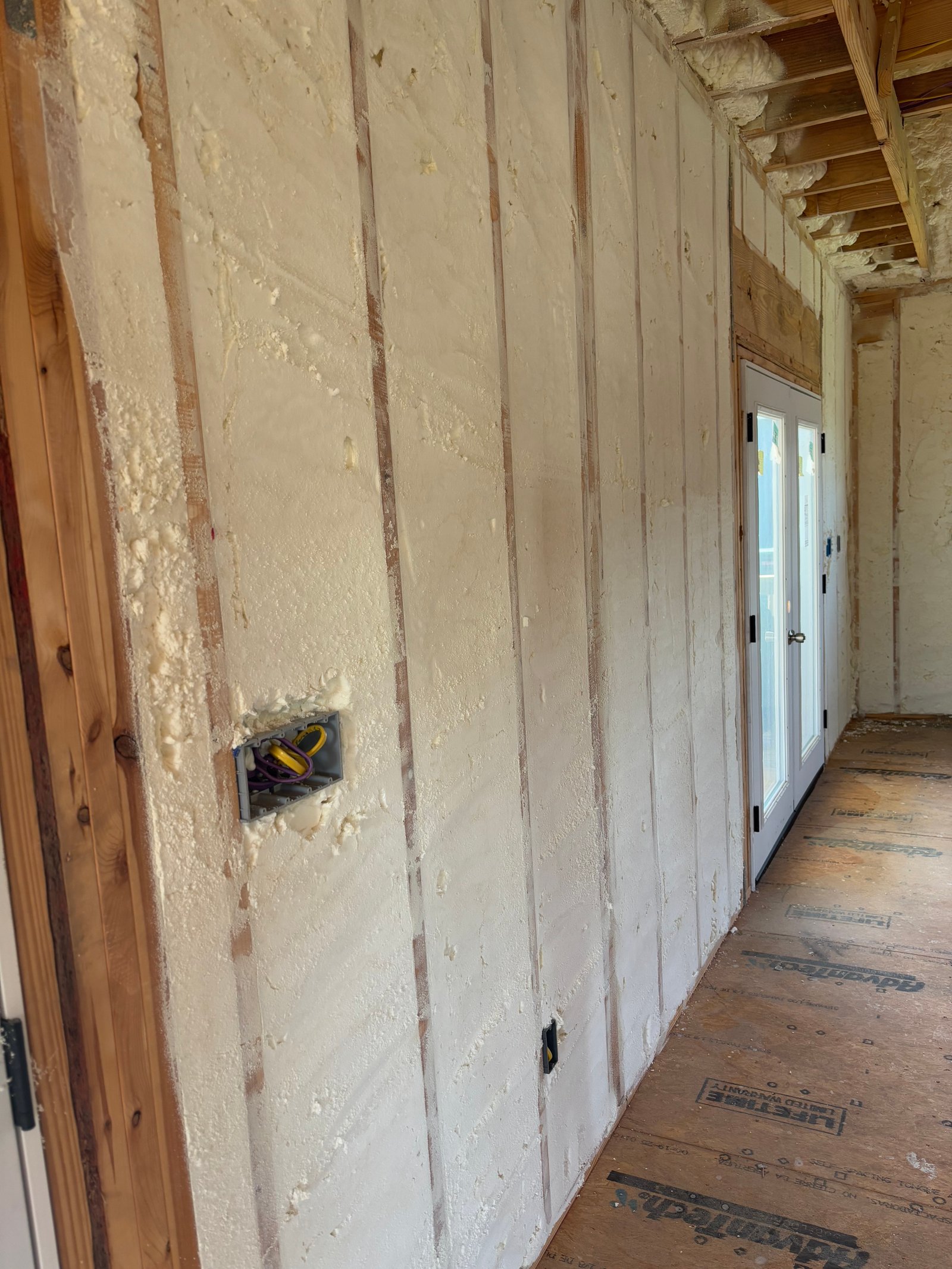 Open cell spray foam insulation on walls