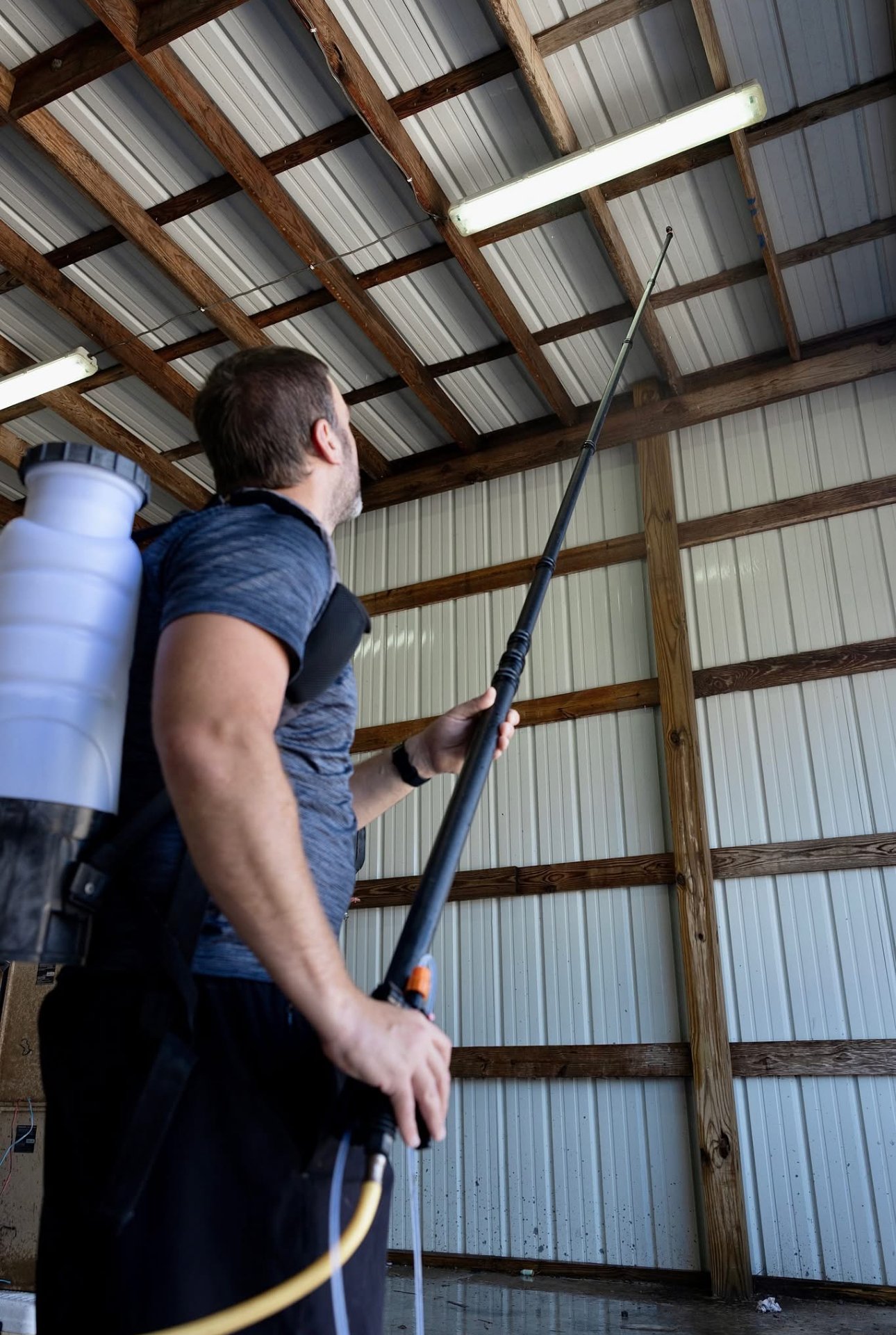 Bayou Spray Foam technician spraying foam in metal building